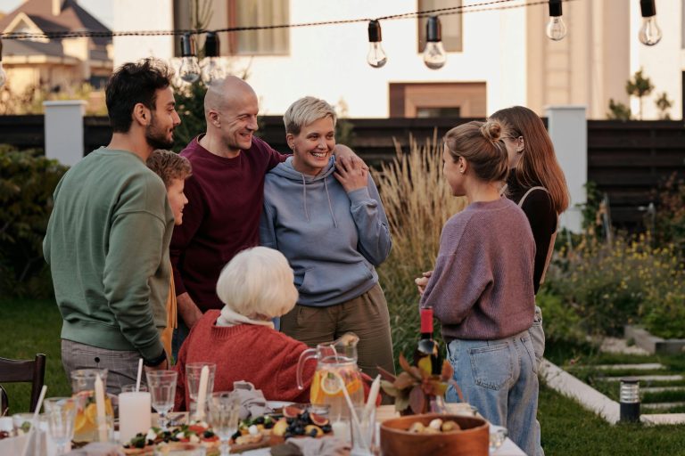 A joyful group of adults and seniors enjoying a lively garden get-together.